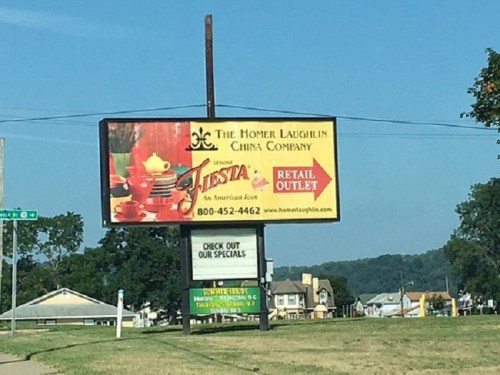 Billboard advertising The Homer Laughlin China Company and its retail outlet for Fiesta dinnerware.