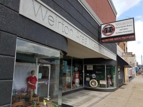 Exterior view of the Weirton Area Museum and Cultural Center, featuring a sign and a display window.