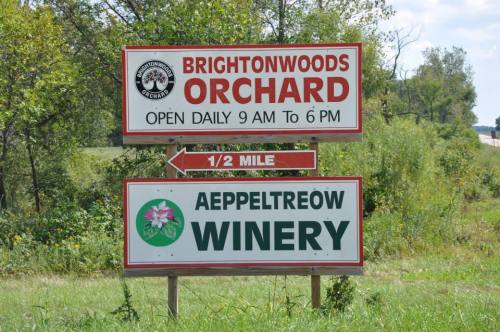 Sign for Brightonwoods Orchard and Aeppletroew Winery, indicating open hours and distance to the winery.