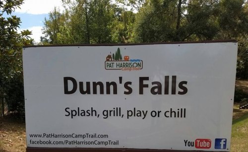 Sign for Dunn's Falls at Pat Harrison Camp Trail, promoting activities like splashing, grilling, playing, and relaxing.