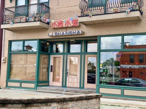 Exterior of a restaurant named "Li Shanghai," featuring large windows and colorful decorations above the entrance.