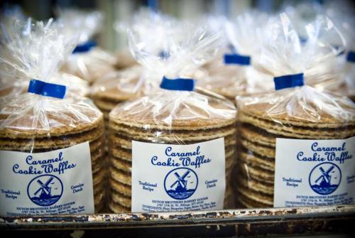 A display of packaged caramel cookie waffles stacked neatly in clear bags.