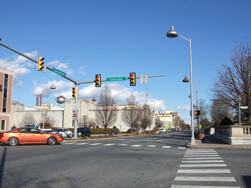 Traffic lights at an intersection with Cocoa Ave, featuring a clear blue sky and a few cars on the road.