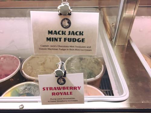 Two ice cream flavor signs: "Mack Jack Mint Fudge" and "Strawberry Royale" displayed in a freezer.