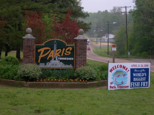 Sign welcoming visitors to Paris, Tennessee, featuring a replica of the Eiffel Tower and a banner for the World's Biggest Fish Fry.