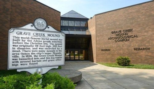 Sign for Grave Creek Mound in front of the Grave Creek Mound Archaeological Complex, showcasing its historical significance.