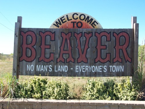 Sign welcoming visitors to Beaver, with the tagline "No Man's Land - Everyone's Town" against a clear blue sky.