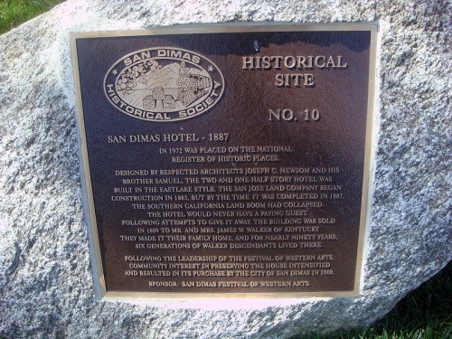 Plaque detailing the San Dimas Hotel's history, established in 1887, recognized as a historical site.