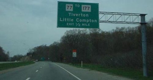 Highway sign indicating exit for Tiverton and Little Compton, ½ mile ahead.