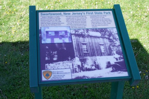 Sign about Swartswood State Park, New Jersey's first state park, featuring historical information and a black-and-white photo.
