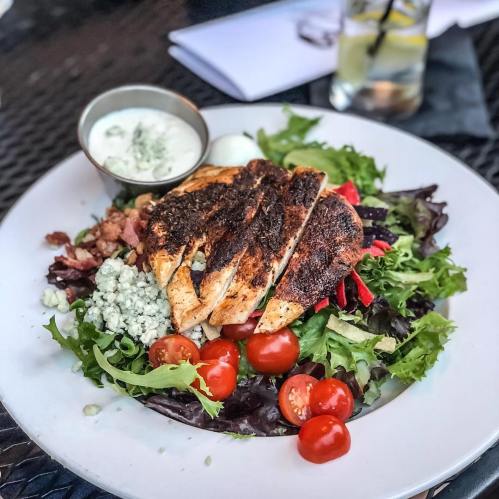 Grilled chicken on a bed of mixed greens, cherry tomatoes, bacon, and blue cheese, served with a creamy dressing.
