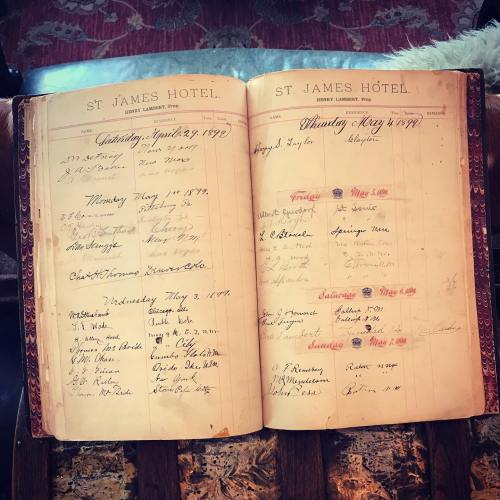 Open vintage hotel register with handwritten entries for April and May 1890, featuring guest names and dates.
