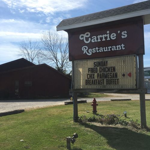 Sign for Carrie's Restaurant advertising Sunday specials: Fried Chicken, Chicken Parmesan, and Breakfast Buffet.