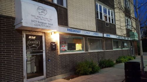 Exterior of Jennifer's restaurant, featuring a sign with hours and menu options, located on Simpson Street.