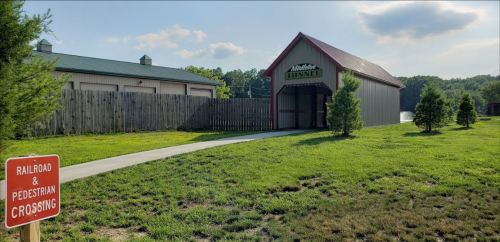 A pathway leads to a red-roofed building labeled "Middletown Tunnel," with a railroad crossing sign nearby.