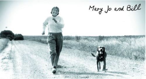 A woman jogs along a dirt road with a dog beside her, with "Mary Jo and Bill" written above.