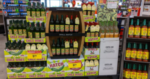 Display of various wines and sauces, featuring "Chile Wines" and "Hatch" products, with price tags visible.