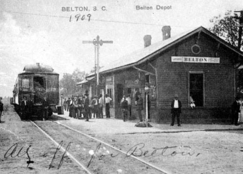 Historic black-and-white photo of Belton Depot in South Carolina, 1909, with a train and people waiting on the platform.