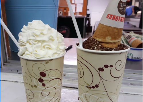 Two ice cream treats: one cup with whipped cream and another with a cone topped with chocolate sprinkles.
