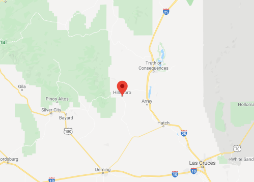 Map showing Hillsboro, New Mexico, marked with a red pin, surrounded by green areas and nearby towns.