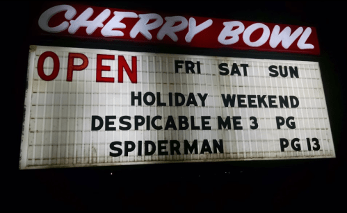 Sign for Cherry Bowl: "OPEN Fri, Sat, Sun. Holiday Weekend. Despicable Me 3 (PG), Spiderman (PG-13)."