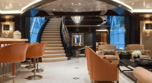 Luxurious interior of a modern lounge with a staircase, elegant seating, and stylish decor.
