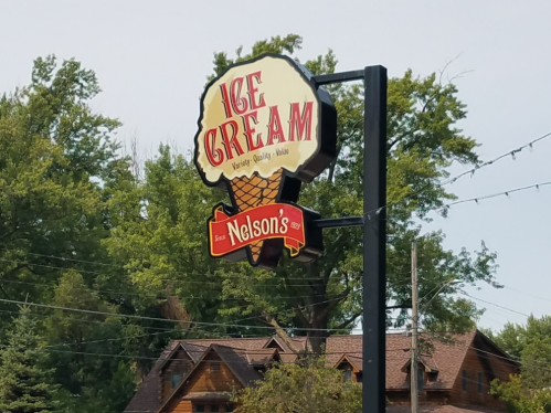 Sign for Nelson's Ice Cream featuring a large ice cream cone graphic and the text "Ice Cream" above.