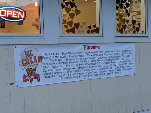 Banner displaying various ice cream flavors at Nelson's, including Java Chunk, Cookies & Cream, and Caramel Turtle Cheesecake.