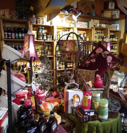 A cozy shop filled with colorful jars, decorative items, and festive decor, creating a warm, inviting atmosphere.