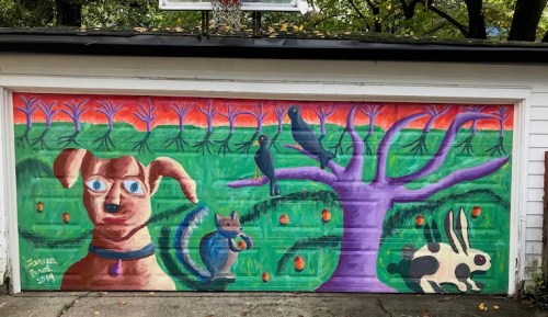 Colorful mural on a garage featuring a dog, a squirrel, birds, a rabbit, and a vibrant tree with orange fruits.