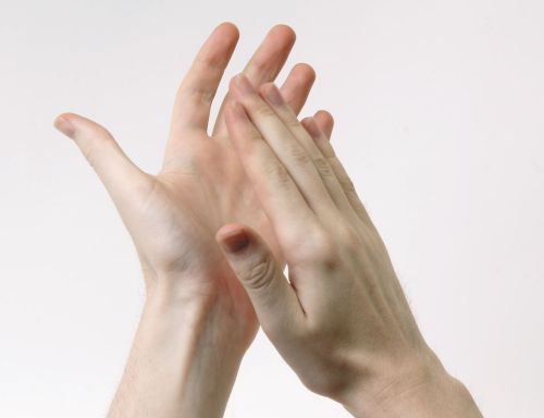 Two hands clapping together against a plain white background.