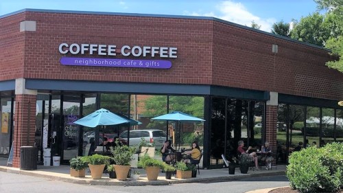 A brick café with outdoor seating, umbrellas, and potted plants, labeled "Coffee Coffee neighborhood café & gifts."
