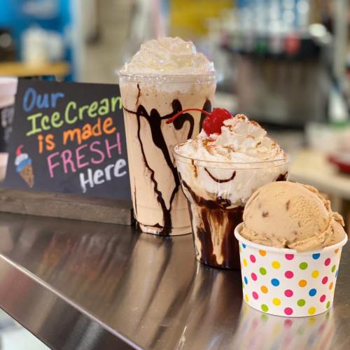 Three delicious ice cream treats: a milkshake, a sundae, and a cup of ice cream, with a sign saying "Our Ice Cream is made FRESH Here."