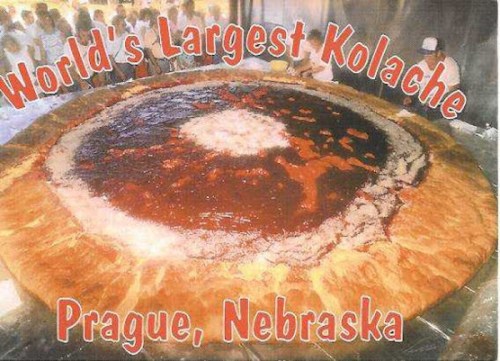 A giant kolache topped with fruit filling, labeled "World's Largest Kolache," in Prague, Nebraska.