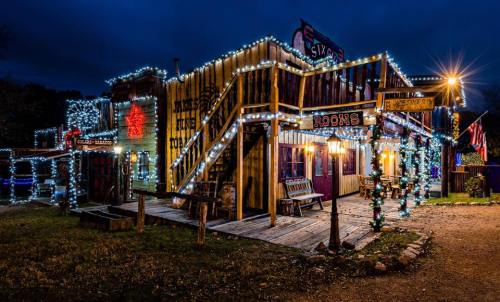 A brightly lit, festive building with colorful lights and decorations, set against a dark evening sky.