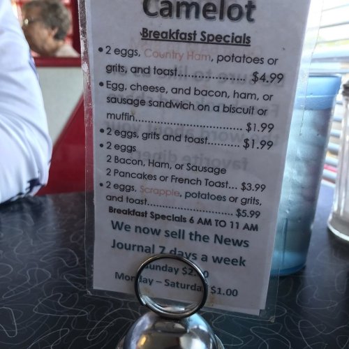 Menu displaying breakfast specials at Camelot, including various egg and meat options with prices.