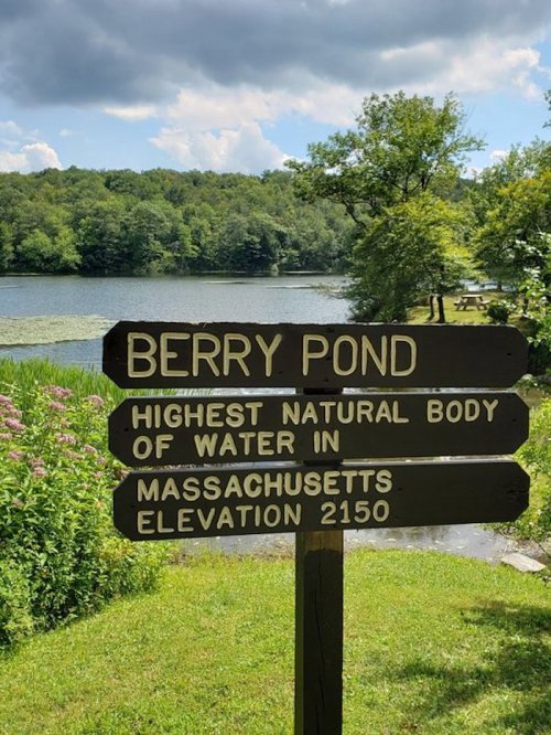 Signpost at Berry Pond, indicating it's the highest natural body of water in Massachusetts, elevation 2150 feet.