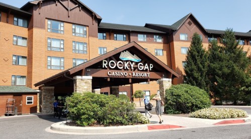 Exterior view of Rocky Gap Casino Resort, featuring a wooden entrance and landscaped surroundings.