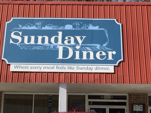 Sign for "Sunday Diner" with a tagline: "Where every meal feels like Sunday dinner." Building exterior visible.
