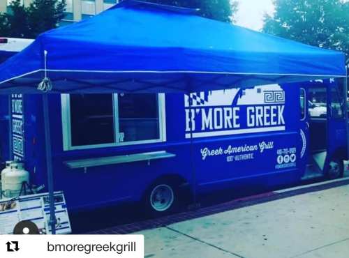 A blue food truck with "B'More Greek" signage, parked on a street under a blue canopy.
