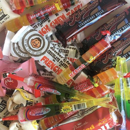 A colorful assortment of candies, including gummies, lollipops, and chocolate treats, piled together.