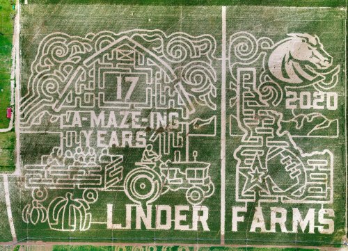 Aerial view of a corn maze celebrating 17 years of Linder Farms, featuring a tractor and various designs.