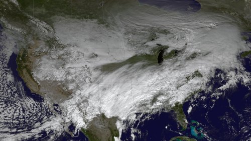 Satellite image showing a large cloud cover over the central and southern United States, with clear skies in the southeast.
