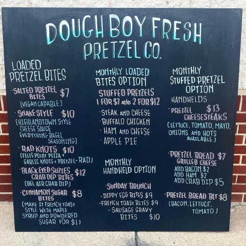 Menu board for Dough Boy Fresh Pretzel Co. featuring various pretzel options and prices.