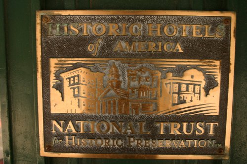 Bronze plaque reading "Historic Hotels of America" and "National Trust for Historic Preservation" with architectural designs.