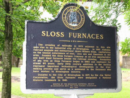 Historical marker for Sloss Furnaces, detailing its significance in Birmingham's industrial history and railroad development.