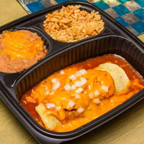 A black takeout container with an enchilada topped with cheese and onions, rice, and refried beans.