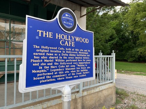 Sign for The Hollywood Cafe in Mississippi, detailing its history and connection to blues music and notable performers.