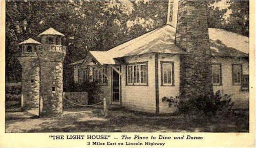 A vintage postcard of "The Light House," a dining and dancing venue with stone towers, located on Lincoln Highway.