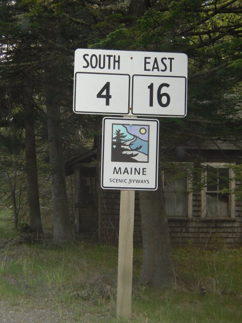 Road sign indicating South on Route 4 and East on Route 16, with a Maine Scenic Byways logo below.